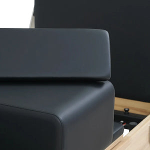 Foldable home Pilates reformer stored against wall — compact design by Ava Reform